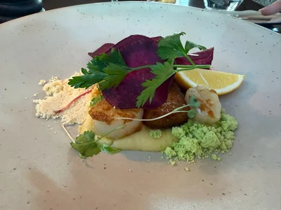 Plated scallop dish served at The Woolshed at Ayrburn