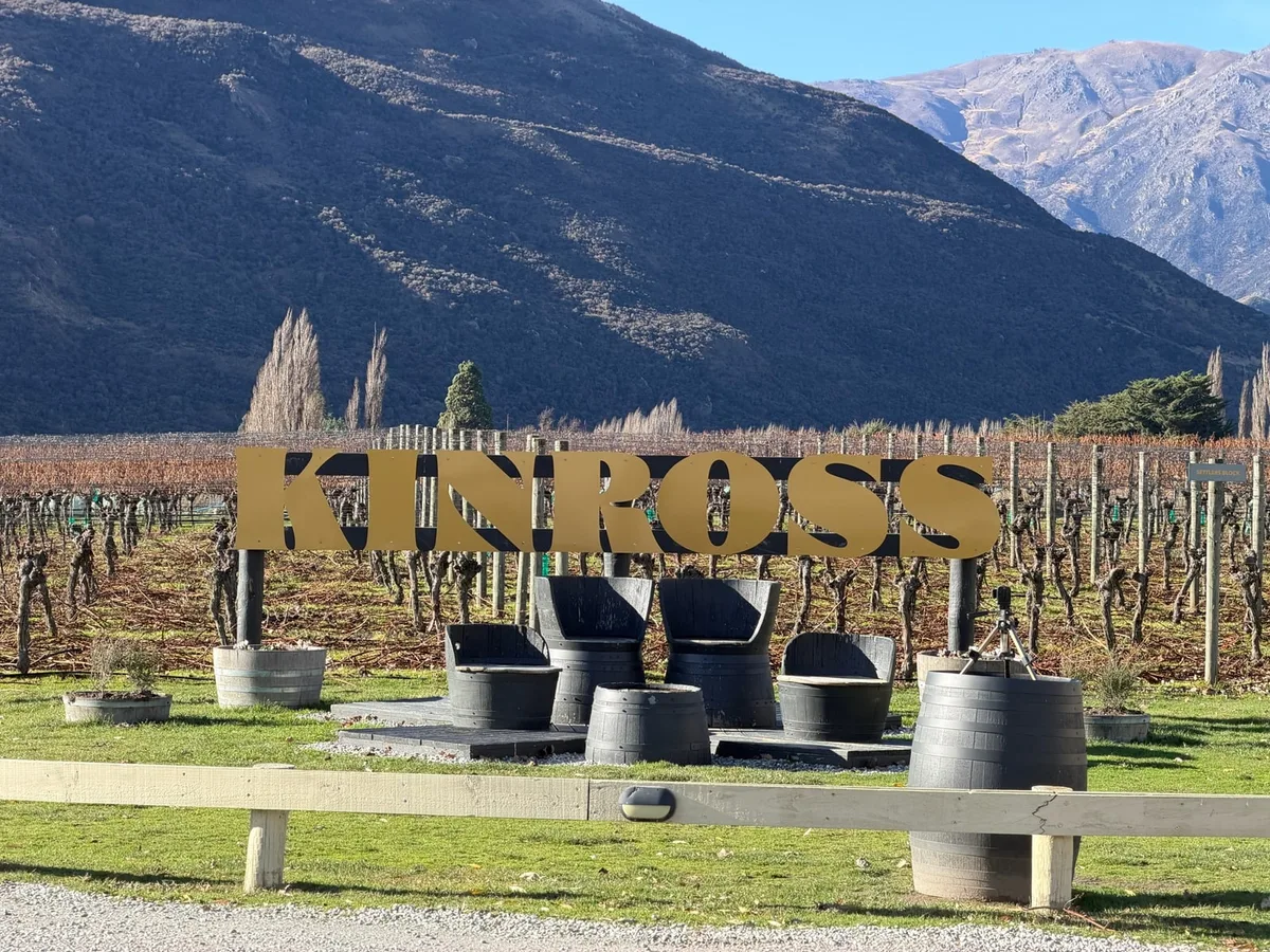 Kinross sign and vineyard against the Central Otago mountains
