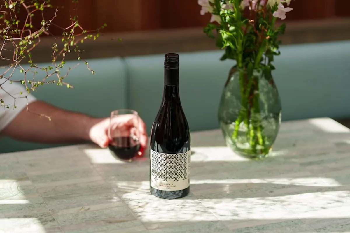 X Wines bottle and glass on a table